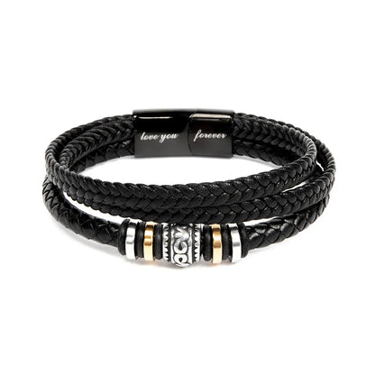 Engraved black braided leather bracelet with metal beads on a white background